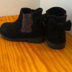 Black suede boots with bows on back.